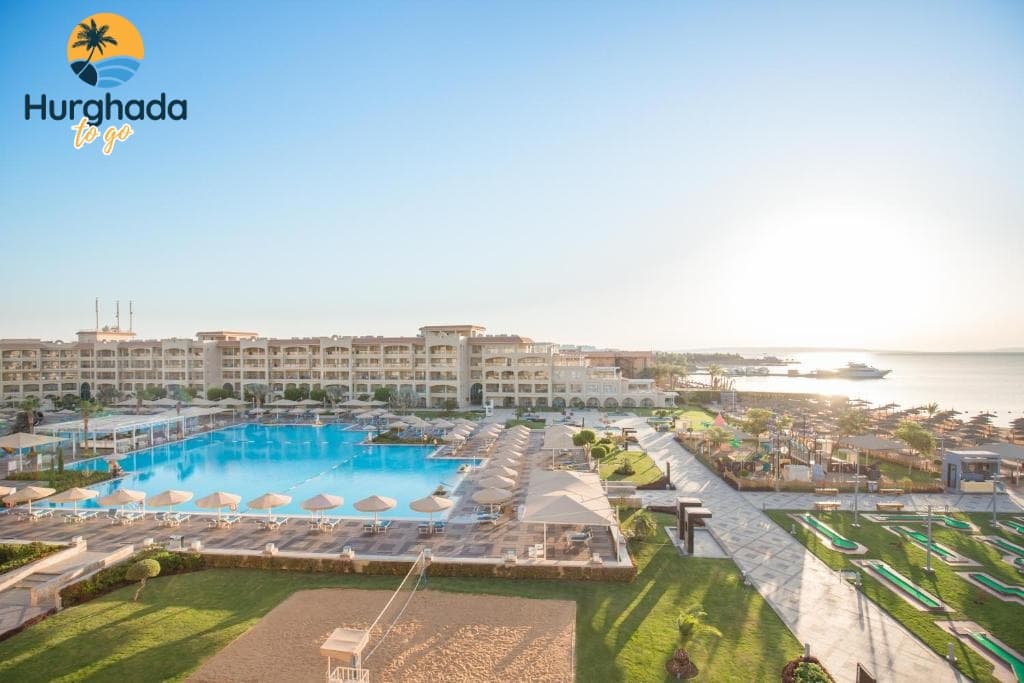 Pickalbatros White Beach Resort, Hurghada – Best Deals & Reviews 2026 is one of the most sought-after luxury beachfront resorts on the Red Sea, offering a perfect blend of comfort, elegance, and five-star hospitality. Known for its prime location on Hurghada Promenade, crystal-clear waters, and family-friendly facilities, this resort has become a top choice for travelers looking for an unforgettable stay in 2026. Whether you are planning a romantic escape, a family holiday, or a relaxing week by the sea, Pickalbatros White Beach Resort Hurghada delivers a world-class experience from the moment you arrive. Guests love the resort’s private sandy beach, expansive outdoor pools, and kids aqua park, making it ideal for both couples and families. With a wide variety of international restaurants, all-inclusive dining options, and professionally managed entertainment programs, every day at the resort feels effortlessly enjoyable. Travelers can also pamper themselves at the spa & wellness center, enjoy daily activities, or relax in one of the stylish rooms and suites—each designed to offer comfort, privacy, and stunning views. In this guide, you’ll find a full breakdown of everything the resort offers: top features, room categories, dining options, activities, spa services, booking tips, and the best deals for 2026. Whether you’re comparing hotels or planning your upcoming vacation, this detailed overview will help you discover why Pickalbatros White Beach Resort remains one of Hurghada’s leading luxury stays. Why Pickalbatros White Beach Is One of Hurghada’s Top Luxury Family Resorts Families choose this beachfront paradise for its warm atmosphere, spacious facilities, and unforgettable Red Sea experiences. The resort offers a seamless blend of luxury and comfort through its bold family-friendly amenities, including the lively Kids Aqua Park, multiple outdoor pools, and a beautifully maintained private beach where parents can relax while children play safely. Guests appreciate the thoughtful details—smooth check-ins, attentive staff, and effortless access to entertainment, sports, and relaxation. With a wide range of room types designed for couples and families, every stay feels personalized and worry-free. Whether enjoying the evening shows, savoring international cuisine, or exploring the promenade, travelers find everything they need for a memorable escape with bold Hurghada luxury stays and exceptional value. Prime Location: Directly on Hurghada Promenade & Minutes from Marina The resort’s location is one of its strongest highlights, placing guests right on the vibrant bold Hurghada Promenade and within minutes of the scenic bold Hurghada Marina. This prime setting makes it effortless to explore the city’s top attractions, from beachfront cafés to boutique shops and nightlife spots. Smooth private transfers, quick access to the airport, and convenient transportation options make the journey stress-free from start to finish. Guests can enjoy morning walks along the promenade, book water adventures, or head to the marina for dining and Red Sea excursions. The combination of beachfront relaxation and city energy creates a perfect balance for travelers seeking both serenity and excitement, making this location one of the most desirable in bold Hurghada holidays. Easy & Secure Booking Reserve your unforgettable Pickalbatros White Beach Resort, Hurghada stay now. Select your dates, room or villa, and enjoy luxury accommodations, gourmet dining, and world-class activities with ease. Check-in Check-out Adults 1 Adult 2 Adults 3 Adults 4 Adults Children 0 Children 1 Child 2 Children 3 Children Room / Villa Deluxe Room Junior Suite Pool View with Jacuzzi Royal Suite Sea View with Jacuzzi Deluxe Triple Room Large Family Room Special Offer - Large Family Room - Egyptians & Residents Only Special Offer - Deluxe Double Room - Egyptians & Residents Only Special Offer - Deluxe Triple Room - Egyptians & Residents Only Deluxe Room with Side Sea View Deluxe Room with Pool View Honeymoon Room Deluxe Single Room Executive Sea View Room Special Requests  Check Availability & Book Now 🌐 Official Website: hurghadatogo.com 📧 Email: Booking@hurghadatogo.com 📱 WhatsApp: +201009255585 For quick personalized assistance, use WhatsApp Chat Pickalbatros White Beach Resort Top Features Private Sandy Beach, 5-Star Facilities & 9 Outdoor Pools The resort’s pristine bold private sandy beach offers a peaceful stretch of golden shoreline where guests can unwind beside the crystal-clear Red Sea. The atmosphere feels calm, refreshing, and irresistibly welcoming, making it ideal for families, couples, and relaxation seekers. Surrounding the beach, you’ll find bold 5-star facilities designed for comfort—luxurious sunbeds, attentive beach service, and shaded areas for quiet moments. Guests can move effortlessly between the sea and the resort’s bold 9 outdoor pools, each offering a unique mood, from family-friendly spaces to quiet adults-only relaxation zones. Smooth transfers and easy internal pathways make navigation simple, ensuring that your stay flows naturally from poolside lounging to beachfront serenity, enhancing the experience of bold luxury Hurghada holidays in every detail. Kids Aqua Park, Family Zones & Child-Friendly Activities Families love the lively spirit of the bold Kids Aqua Park, where colorful slides, splash pools, and safe play zones create magical moments for children of all ages. Parents appreciate how easy it is to move around the dedicated bold family zones, designed to keep everyone connected yet relaxed. Supervised programs, creative workshops, mini-games, and outdoor activities allow kids to explore, learn, and play while parents enjoy their own quiet time. Every corner is built with safety, joy, and comfort in mind, making family travel smoother and more enjoyable. With thoughtful staff, seamless transportation within the resort, and well-planned spaces, the atmosphere feels warm, engaging, and deeply family-centered—one of the key reasons guests return for bold Hurghada family vacations year after year. Daily Entertainment: Live Shows, DJ Nights & Animation Team Evenings at the resort come alive with an exciting lineup of bold live shows, immersive performances, and energetic bold DJ nights that create a vibrant atmosphere for guests of all ages. The dedicated bold animation team brings joy to every part of the day, offering dance lessons, games, competitions, and light-hearted fun that keeps the energy flowing. Smooth access to entertainment areas, well-organized schedules, and diverse themes ensure that every night feels unique and memorable. Whether you're laughing at a comedy show, enjoying a cultural performance, or dancing under the stars, the experience feels human, warm, and emotionally uplifting. These entertainment moments seamlessly enrich the overall stay, adding color and excitement to bold Red Sea holidays. Spa, Wellness Center, Jacuzzi & Professional Gym Guests seeking relaxation are naturally drawn to the serene atmosphere of the bold spa & wellness center, where soothing treatments melt away tension and restore balance. Professional therapists offer massages, facials, body scrubs, and calming rituals designed to refresh both mind and body. The tranquil bold Jacuzzi and steam areas provide a peaceful escape, while fitness lovers can enjoy the fully equipped bold professional gym, complete with modern machines and spacious workout zones. Smooth access, relaxing music, and warm lighting create an environment that feels both luxurious and emotionally grounding. Whether starting the day with a workout or ending it with a rejuvenating treatment, guests experience a deep sense of renewal—perfect for those seeking bold luxury relaxation in Hurghada. Rooms & Suites at Pickalbatros White Beach Resort Superior Room Garden View – Affordable Luxury for Couples Couples searching for peace and comfort will feel instantly connected to the calming ambiance of the bold Superior Room Garden View, where lush greenery creates a serene backdrop for a romantic getaway. The room blends warm design with practical comfort, offering a soft bed, modern bathroom, and spacious seating area that encourages relaxation after a day of exploring. Guests can enjoy easy access to the beach, pools, and dining areas, thanks to smooth internal pathways and hassle-free navigation. Many couples appreciate starting their mornings with the gentle sounds of the gardens before heading out to enjoy bold Hurghada activities such as snorkeling or sunset walks. This room category delivers heartfelt simplicity wrapped in bold affordable luxury, making every moment feel intimate and meaningful. Superior Room Pool View – Stylish Stay with Poolside Views The bold Superior Room Pool View welcomes guests with bright, refreshing scenery overlooking the shimmering pools, creating an uplifting atmosphere from sunrise to evening. Designed for comfort and style, the room features modern amenities, a private balcony, and soothing colors that enhance the feeling of relaxation. Guests love the short walking distance to the bold outdoor pools, beach areas, and restaurants, making movement around the resort effortless and enjoyable. Whether you're starting your day with a refreshing swim or winding down with evening entertainment, everything feels close, convenient, and beautifully coordinated. This room suits travelers who want a balance of elegance and energy while enjoying bold Red Sea holiday experiences in a cozy, stylish setting. Superior Room Sea View – Breathtaking Front-Row Red Sea Views Travelers who dream of waking up to stunning blue horizons will be captivated by the bold Superior Room Sea View, offering sweeping panoramic scenes of the Red Sea. The private balcony becomes a personal sanctuary where guests can enjoy morning coffee, gentle breezes, and unforgettable sunrises. Inside, the room combines coastal-inspired décor with premium comfort, creating a peaceful retreat after days filled with swimming, beach walks, and water activities. With quick access to the promenade, pools, and dining venues, moving around the resort feels smooth and stress-free. Emotionally engaging and visually inspiring, this room is perfect for travelers who want a deeper connection with the sea while enjoying bold luxury Hurghada stays filled with beauty and tranquility. Family Room Garden View – Comfortable Stay for Families of 4 The bold Family Room Garden View offers families a warm and welcoming space where comfort, convenience, and thoughtful design come together effortlessly. With enough room for four guests, the layout keeps everyone connected while still providing enough space for personal relaxation. Parents appreciate the calming garden surroundings, safe pathways, and easy access to the bold family zones, pools, and kids’ entertainment areas. Morning routines become smoother, thanks to practical storage, modern amenities, and the relaxing natural view that sets a positive tone for the day. Families can easily transition from room time to beach activities, dining, or the bold Kids Aqua Park, making every moment feel organized and joyful. It's an ideal choice for families seeking comfort, value, and meaningful shared memories. Family Room Pool View – Perfect for Parents & Kids Families who value comfort and togetherness will instantly appreciate the warm ambiance of the bold Family Room Pool View, where relaxing pool scenery sets the tone for joyful mornings and peaceful evenings. Parents love the convenience of stepping out and reaching the bold outdoor pools within moments, allowing kids to swim, play, and enjoy fun activities throughout the day. The room’s generous layout ensures everyone has space to unwind, making transitions between rest, meals, and entertainment effortless. With close proximity to family dining areas, kids’ programs, and the lively bold family zones, moving around feels natural and stress-free. Every detail—from the tranquil view to the thoughtful amenities—creates a nurturing environment ideal for bold Hurghada family holidays filled with shared laughter and memorable experiences. Family Suite – Spacious 2-Room Setup for Large Families The beautifully designed bold Family Suite offers a spacious two-room configuration that gives large families the freedom to stay connected while enjoying moments of privacy. Parents appreciate the separate sleeping areas, allowing them to rest peacefully while children enjoy their own cozy space. With smooth access to the pools, bold Kids Aqua Park, and dining areas, daily routines become incredibly convenient. The suite’s warm décor, modern facilities, and family-centered layout create a sense of comfort that makes every day feel easy and enjoyable. Whether preparing for a day by the beach or returning from outdoor adventures, families experience harmony, comfort, and emotional closeness. This exceptional layout makes it a perfect choice for travelers seeking bold family-friendly luxury in Hurghada. Swim-Up Room – Direct Pool Access for a VIP Stay Guests seeking exclusivity and effortless relaxation will fall in love with the bold Swim-Up Room, where private terraces open directly into shimmering pool waters. This unique setup offers a VIP touch—allowing guests to enjoy early-morning swims, peaceful sunbathing, and intimate poolside moments without leaving their room. Inside, the space feels stylish and serene, complete with premium amenities and soothing décor. Smooth pathways connect the room to beach areas, restaurants, and entertainment zones, making movement around the resort comfortable and intuitive. This category is perfect for couples and honeymooners looking for privacy, elegance, and emotional connection. The seamless blend of comfort and luxury creates an unforgettable atmosphere, offering one of the most coveted bold Red Sea luxury experiences. Junior Suite Sea View – Premium Comfort with Panoramic Views Travelers who seek elegance and breathtaking scenery will cherish the bold Junior Suite Sea View, where expansive windows and a private balcony frame the Red Sea’s brightest shades of blue. The suite offers generous space, premium bedding, a stylish lounge area, and refined décor that creates a mood of pure relaxation. Waking up to panoramic views becomes a daily emotional highlight, inspiring calm and positivity. With quick access to the pools, promenade, and dining venues, guests can transition smoothly between relaxation and activity. Whether enjoying sunset reflections or peaceful mornings, every moment feels elevated. This suite is ideal for travelers craving bold premium Hurghada stays with a strong connection to the sea. Executive Suite – Luxury Living with Exclusive Privileges For guests who prioritize sophistication, comfort, and privacy, the bold Executive Suite delivers an unmatched level of luxury. The expansive layout includes elegant living spaces, a refined bedroom, and upgraded amenities that create a prestigious atmosphere. Exclusive privileges—such as priority services, enhanced comfort features, and premium views—add a personalized touch to the experience. The suite’s strategic location ensures quick access to the beach, pools, and bold luxury facilities, making movement seamless and enjoyable. Whether relaxing after a spa session or preparing for a family outing, every detail feels intentional and indulgent. Emotionally warm and beautifully designed, this suite redefines bold high-end Hurghada accommodation, offering unforgettable comfort for discerning travelers. Dining Experience at Pickalbatros White Beach Resort 6 Restaurants Serving International, Italian & Asian Cuisine Guests love the variety and richness offered across the resort’s bold 6 restaurants, each delivering a unique culinary journey crafted with passion and global flavors. Whether exploring bold international cuisine, indulging in comforting bold Italian dishes, or discovering vibrant bold Asian specialties, every meal feels like a new experience. The warm atmosphere, friendly service, and beautifully presented dishes create a memorable dining routine for couples and families alike. Easy access from rooms and pool areas ensures smooth transitions between activities and meals, allowing guests to enjoy lunch after a morning swim or savor dinner after a peaceful walk along the promenade. With fresh ingredients, themed nights, and an inviting setting, dining becomes one of the highlights of your bold Hurghada holiday. All-Inclusive Dining: Breakfast, Lunch, Dinner & Snacks The resort’s bold all-inclusive dining concept provides guests with a seamless culinary experience from sunrise to late evening. Each day begins with a generous bold breakfast buffet, followed by a variety of lunch and dinner options that cater to every taste—from light salads to flavorful grills and international favorites. Between meals, guests can enjoy tasty bold snacks, ice cream, and refreshing treats found throughout the resort. Smooth access to dining venues makes the experience effortless, allowing families to enjoy meals without rushing or planning. Whether returning from the beach, the pool, or an afternoon activity, guests always find something satisfying and freshly prepared. This flexible dining style enhances comfort and ensures carefree, enjoyable bold Red Sea vacations. Bars, Pool Bars & Beachfront Refreshments Refreshing moments are easy to find thanks to the resort’s vibrant collection of bold bars, pool bars, and beachfront refreshment spots. Guests can sip cooling mocktails by the water, enjoy freshly squeezed juices after a swim, or relax with a warm drink during the evening entertainment. The bold pool bars create a lively atmosphere where families and couples can unwind while staying steps away from the action. Meanwhile, the beachfront bar offers soothing views of the Red Sea, making it perfect for sunset drinks or a mid-day break. Convenient locations and friendly bartenders ensure quick service and smooth experiences throughout the day. These refreshing stops add a joyful rhythm to the stay, completing the essence of bold Hurghada leisure and relaxation. Resort Activities & Entertainment Water Sports: Snorkeling, Windsurfing & Parasailing Feel the rush of freedom as you step onto the crystal shoreline and dive into a world of adventure with bold water sports that turn every moment into a story worth remembering. Whether you’re drifting gently above vibrant coral gardens during bold snorkeling, gliding across the Red Sea’s shimmering surface with bold windsurfing, or soaring high above the coast through bold parasailing, each experience is crafted to ignite your senses. Guests love how easy and comfortable the transitions are—from beach relaxation to thrilling activity—thanks to smooth access points, professional instructors, and safety-first guidance. These immersive adventures offer not only excitement but also a deeper connection to bold Hurghada marine life, making your stay unforgettable. Fitness, Beach Workouts, Aerobics & Water Gymnastics Start your morning with a refreshing sense of renewal as you join energizing bold fitness sessions designed to elevate your mood and strengthen your body. From sunrise bold beach workouts to dynamic bold aerobics classes and uplifting bold water gymnastics, each activity blends movement with the natural beauty of the Red Sea coastline. The supportive trainers create motivating routines that suit all levels, ensuring every guest feels confident and engaged. The seamless flow from indoor gym facilities to outdoor training zones adds variety to your wellness journey. These curated experiences not only boost physical vitality but also offer mental clarity, helping you reconnect with yourself in a calm, inspiring environment enriched by warm breezes and rhythmic waves. Mini Club, Kids Cinema, Playgrounds & Daily Supervised Programs Families can relax knowing their little ones are fully immersed in joyful, safe, and creative moments through the resort’s bold Mini Club and vibrant bold kids programs. Children enjoy movies at the bold Kids Cinema, imaginative play at colorful bold playgrounds, and a full schedule of bold supervised activities designed to spark curiosity and build confidence. Friendly, trained staff guide them through themed games, arts and crafts, and outdoor adventures, giving parents peaceful time to unwind while staying close. Smooth transitions between activities ensure kids are always entertained, while the thoughtful setup enhances comfort and security. These enriching experiences create cherished holiday memories and allow every family member to enjoy the perfect balance of relaxation and excitement. Volleyball, Tennis, Table Tennis & Multi-Sport Facilities Active travelers will find endless ways to stay energized with a variety of bold sports facilities that encourage friendly competition and lively social moments. Whether you’re diving into an intense match of bold beach volleyball, enjoying a fast-paced game on the bold tennis courts, or sharing fun challenges over bold table tennis, each experience brings people together in the sun-soaked atmosphere of Hurghada. The resort’s bold multi-sport areas are designed for smooth, comfortable play with high-quality surfaces, modern equipment, and convenient access. These athletic experiences create a refreshing balance between leisure and movement, inviting guests to celebrate teamwork, connection, and the simple joy of active holiday fun in a beautifully maintained setting. Pools, Aqua Park & Beach Experience 9 Outdoor Pools Including Heated Options Guests are instantly drawn to the resort’s stunning collection of bold 9 outdoor pools, thoughtfully designed to provide relaxation and fun for every age group. With bold heated pools available during cooler months, swimming becomes a pleasure all year round, offering comfort and warmth even in the early mornings or evenings. The expansive layout allows families, couples, and solo travelers to find the perfect spot to unwind, sunbathe, or dive into refreshing waters. Seamless access from rooms, bars, and dining areas makes daily routines effortless, while attentive pool staff ensure comfort and safety. The combination of modern design, soothing ambiance, and varied pool experiences elevates every moment, making bold Hurghada luxury holidays truly unforgettable. Kids Aqua Park with Slides & Splash Areas Little adventurers are treated to a world of excitement at the resort’s bold Kids Aqua Park, where colorful slides, playful splash areas, and shallow pools create endless fun in a safe environment. Children can enjoy laughter-filled hours swimming, sliding, and exploring, while parents relax nearby, confident in the attentive supervision and child-friendly facilities. The Aqua Park is perfectly integrated into the resort’s bold family zones, allowing easy transitions between dining, playtime, and rest. Bright, vibrant designs and strategically placed safety features ensure every splash moment is both thrilling and secure. For families seeking a mix of adventure and relaxation, this setup offers an ideal balance, making every day a highlight of their bold Red Sea family vacation. Sunbeds, Umbrellas, Towel Service & Beach Activities Comfort and convenience await guests along the resort’s private shoreline, where bold sunbeds, bold umbrellas, and bold towel service ensure effortless relaxation from morning to sunset. Families and couples can enjoy the soft sandy beach while engaging in lively bold beach activities, from casual volleyball matches to guided water exercises. The layout allows seamless movement between pools, dining areas, and the Red Sea, offering a fluid experience of leisure and adventure. Attentive staff provide friendly service throughout the day, keeping refreshments close and ensuring guests feel cared for at every moment. This harmonious blend of sun, sand, and service defines the essence of a perfect bold Hurghada beachfront experience, creating memories that linger long after departure. Spa & Wellness Facilities Full Spa Menu: Massages, Facials & Beauty Treatments Indulge in a world of serenity with the resort’s extensive bold spa menu, designed to rejuvenate both body and mind. Guests can select from soothing bold massages, revitalizing bold facials, and luxurious bold beauty treatments, all performed by highly trained therapists who prioritize relaxation and personal care. The spa environment, with its tranquil ambiance, soft lighting, and aromatic essences, creates a perfect escape from daily stress. Conveniently located near the main resort areas, the spa allows seamless transitions between morning activities and afternoon pampering. Every session is tailored to individual needs, ensuring guests experience complete rejuvenation. This carefully curated wellness journey transforms a regular vacation into an unforgettable bold Hurghada luxury spa experience. Sauna, Steam Room & Traditional Turkish Hammam Enhance your sense of well-being with the resort’s thoughtfully designed bold sauna, steam room, and traditional Turkish hammam, each offering unique therapeutic benefits. Guests can unwind in the dry heat of the bold sauna, detoxify and relax in the bold steam room, or immerse themselves in the culturally rich ritual of the bold Turkish hammam. These wellness facilities provide a holistic approach to relaxation, combining physical relief with mental clarity. Convenient access from the pool, fitness, and spa areas ensures effortless integration into your daily routine. Surrounded by calming interiors and soothing scents, every visit feels like a luxurious retreat, making this wellness haven a cornerstone of your bold Hurghada holiday. Booking Information & Prices Best Deals & Seasonal Discounts Available Now Unlock exclusive bold deals for your Hurghada getaway, ensuring a luxurious stay at unbeatable prices. Seasonal discounts make it possible to experience bold family-friendly resorts, bold private beaches, and top-tier bold Red Sea amenities without compromise. Guests enjoy early access to promotions, including limited-time offers on suites, pool views, and beachfront rooms, perfect for couples, families, or solo travelers seeking bold affordable luxury. Transparent booking and easy online reservations enhance convenience, allowing you to secure your dream holiday confidently. Personalized support helps travelers choose the ideal package, combining leisure, adventure, and comfort in one seamless experience. These deals make it simple to enjoy bold Hurghada vacation highlights like pools, water parks, and spa retreats while staying within your budget. Price Range: Starting from $176 per Night Room rates begin at bold $176 per night, offering a competitive entry point to an unforgettable bold luxury Red Sea stay. Prices vary depending on room types, such as garden view, pool view, and premium sea view suites, all equipped with bold modern amenities. Guests benefit from value-added experiences including access to pools, private beaches, kids’ zones, and sports facilities, ensuring a complete bold Hurghada family vacation. Flexible options accommodate short getaways, week-long stays, or extended holidays, making planning effortless. Seasonal pricing and exclusive promotions create opportunities for couples and families to enjoy premium services without overspending. This carefully structured price range ensures transparency while highlighting the luxury, comfort, and bold all-inclusive experiences offered. Extra Services: Early Check-In, Late Check-Out & VIP Add-Ons Enjoy the convenience of bold early check-in, allowing guests to start their bold Hurghada holiday without delay. Bold late check-out options provide flexibility for relaxed departures and extended enjoyment of pools, beach, and resort facilities. VIP add-ons include personalized concierge service, exclusive bold suite amenities, private pool access, and curated spa treatments. Extra services enhance the guest experience with attention to detail, ensuring that couples, families, and solo travelers feel valued and cared for. Tailored packages integrate transportation, dining upgrades, and activity reservations to create seamless bold Red Sea luxury experiences. These thoughtful add-ons elevate your stay, making every moment memorable and giving travelers the full luxury resort experience they deserve. Policies & Guest Information Check-In & Check-Out Times Guests can bold check in from 2:00 PM, allowing ample time to settle into their bold Hurghada luxury rooms after arriving at the airport or exploring the promenade. Bold check-out is until 12:00 PM, providing flexibility to enjoy morning pools, private beaches, or spa sessions before departure. Early arrivals and late departures can be arranged as bold add-on services, ensuring a stress-free start or end to your holiday. Convenient front desk support guarantees smooth luggage handling, quick room assignments, and guidance for resort facilities, enhancing the bold family-friendly experience. Travelers can synchronize check-in with transport services from Hurghada International Airport, facilitating seamless arrival and departure. These policies balance bold luxury convenience with practical timing, allowing families, couples, and solo adventurers to maximize their stay. Family Policies, Safety Features & Resort Guidelines Children of all ages are warmly welcomed, making it an ideal bold family-friendly resort destination. Safety is prioritized with secure pool areas, monitored kids’ zones, and 24-hour staff supervision to ensure worry-free relaxation. Family guidelines include clear instructions for bold water park use, beach safety, and poolside activities to maximize fun responsibly. On-site amenities like childproof rooms, playgrounds, and supervised programs cater to parents seeking comfort and peace of mind. Resort staff provide guidance on local attractions and transport, helping families enjoy bold Red Sea adventures safely and efficiently. These well-structured policies create a secure and welcoming environment, allowing guests to focus entirely on fun, relaxation, and quality family time. Accessibility, Adapted Rooms & Special Requests Fully accessible facilities ensure that all guests, including those with mobility challenges, enjoy a bold Hurghada luxury experience. Adapted rooms feature ramps, wide entrances, and customized amenities for comfort, safety, and independence. Guests can request special accommodations, such as additional cribs, connecting rooms, or dietary requirements, through the front desk or online reservation. The resort staff are trained to respond to bold personalized needs, enhancing inclusivity and guest satisfaction. Accessibility extends to pools, beaches, and wellness areas, ensuring seamless enjoyment of bold private beaches, pools, and spa treatments. By providing thoughtful solutions for every requirement, the resort guarantees that every traveler experiences bold Red Sea hospitality without compromise. Why Choose Pickalbatros White Beach Resort? Luxury Facilities with Top-Rated Family Services Experience unmatched comfort with bold luxury facilities, including private pools, Jacuzzis, and contemporary suites designed for ultimate relaxation. The resort offers bold family-friendly amenities, such as kids’ aqua parks, playgrounds, and supervised daily activities to keep children engaged and safe. Multiple outdoor pools, including heated options, provide year-round enjoyment for both adults and children, while sun loungers and umbrellas enhance poolside relaxation. On-site dining options cater to all ages, offering bold international cuisines, kids’ menus, and all-inclusive meal plans for a seamless family experience. Staff members are highly trained in hospitality, ensuring attentive service, safety supervision, and personalized care for every family member. These thoughtfully designed facilities make it easy to combine leisure, adventure, and quality family bonding, creating a memorable bold Hurghada family holiday. Perfect for Beach Lovers, Families & Long Stays Situated on the private sandy shoreline, the resort offers bold direct beach access for sunbathing, swimming, and water sports enthusiasts. Families benefit from spacious suites, pools, and kids’ entertainment zones, ensuring that children and adults alike enjoy bold family-friendly activities. Long-stay guests can take advantage of full-service amenities, including on-site restaurants, bars, spa, and wellness centers for continuous comfort. Daily entertainment, such as live shows, DJ nights, and beach games, enriches every moment of the stay, creating lasting memories. The resort’s location near Hurghada Marina and promenade allows easy exploration of local attractions while returning to the calm and privacy of bold luxury accommodations. This combination of sun, sand, and premium services makes it an ideal choice for couples, families, and travelers seeking a prolonged bold Red Sea retreat. How to Book with HurghadaToGo Exclusive Prices & Special Offers for White Beach Resort Discover unbeatable bold deals on Hurghada accommodations with seasonal promotions tailored for families, couples, and solo travelers. Enjoy special discounts on luxurious rooms, suites, and poolside options, ensuring a premium stay at an accessible price. Guests can take advantage of exclusive packages that include access to private beaches, bold aqua parks, and all resort activities. Early bird and last-minute offers are available, maximizing value while maintaining the high standards of bold Red Sea luxury resorts. These promotions make it easier to plan dream holidays, combining relaxation, entertainment, and fine dining without compromising on comfort or style. With these exclusive prices, families and couples can enjoy an immersive bold Hurghada experience while keeping the budget in check. Easy Booking, Secure Payments & Instant Confirmation Book your stay effortlessly with a streamlined system that guarantees bold secure online reservations for all room types. Instant confirmation ensures peace of mind, allowing guests to plan transfers, excursions, and resort activities seamlessly. Multiple payment methods, including credit cards and secure gateways, make transactions safe and hassle-free. The system also provides real-time availability for bold family suites, sea view rooms, and pool access rooms, ensuring you select the perfect accommodation. Guests can easily modify dates, request special room arrangements, or add VIP services, enhancing the flexibility of their bold Hurghada stay. This approach ensures a smooth booking journey, prioritizing convenience, security, and the best possible vacation start. Contact Our Team for Customized Hurghada Hotel Packages Personalized service allows travelers to design their perfect getaway, combining accommodations, transfers, and exclusive resort activities. Our experts provide tailored recommendations for families, couples, and adventure seekers, ensuring every aspect of the trip meets expectations. Packages can include bold private beach experiences, spa sessions, aqua park passes, and dining options, creating a fully curated holiday. Direct communication with the team allows guests to request early check-in, late check-out, or any special arrangements. Travelers can also combine their stay with local excursions, snorkeling trips, and Red Sea adventures, all coordinated for convenience and comfort. This level of customization guarantees a stress-free, memorable, and truly bold Hurghada resort experience for every guest. Easy & Secure Booking Reserve your unforgettable Pickalbatros White Beach Resort, Hurghada now through: 🌐 Official Website: hurghadatogo.com 📧 Email: Booking@hurghadatogo.com 📱 WhatsApp: +201009255585 ( For quick personalized assistance WhatsApp Chat ) We also recommend you : The Oberoi Beach Resort, Sahl Hasheesh – Luxury Stay & Discount Booking Pickalbatros Blue Spa – Reviews & Lowest Price Guarant – Hurghada Steigenberger Pure Lifestyle – Book at the Best Price Today - Hurghada SUNRISE Tucana Resort Hurghada – Affordable Rates & Guest Reviews SUNRISE Royal Makadi Resort – Top Reviews & Cheap Booking Rixos Premium Magawish Suites & Villas – Exclusive Deals & Ratings